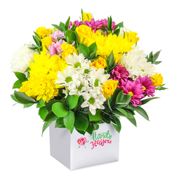 A generously rounded, mixed flower arrangement is shown against a spotless white background, its colours and textures gathering into a cheerful dome that feels both modern and welcoming. The flowers are packed into a crisp, cube-shaped white gift box, giving the bouquet a clean architectural base reminiscent of Clerkenwell's contemporary galleries and studios. At the top and centre, golden yellow chrysanthemums and clusters of petite yellow spray roses create a glowing canopy, their plush, layered petals and tight buds suggesting abundance and joy. Around them, small white daisies with fresh green centres mingle with slightly larger, cushiony white chrysanthemums, adding a cool, luminous calm and softening the edges of the design. Threading through this yellow-and-white harmony are vivid fuchsia and magenta chrysanthemums, some with paler pink highlights, introducing a playful, eye-catching accent that stands out like colourful shopfronts along nearby St John Street. Deep green, glossy foliage encircles and supports the blooms, filling any gaps so the arrangement appears full and lush from every angle. The leaves add a natural sheen and contrast that highlights the brightness of the petals. The white square box that acts as the container reinforces a minimalist, gift-ready look, ideal for placing on a work desk near Farringdon station or as a bold welcome on a kitchen table in a Clerkenwell flat. The overall impression is one of fresh optimism and easy celebration, making the arrangement suitable for birthdays, congratulations, or simply lifting someone's spirits with a same-day flower delivery in the local area.