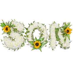 As a florist in Clerkenwell I often describe memorial pieces the way a family might remember a voice-gentle, steady, and unmistakable. This bespoke tribute spells SON in three bold capital letters, each letter densely covered with small, immaculate white chrysanthemums whose layered petals form a plush, tactile surface that invites touch even through the photograph. Dark green ivy vines meander across the composition, their climbing tendrils and matte leaves softening edges and suggesting continuity, while feathered fern fronds and fresh leaf sprays add a lighter green rhythm that defines each curve and angle. Bright sunflowers-one seated on the upper-left of the S, a second settled at the lower curve of the O amid fern fronds, and a third brightening the upper-right of the N-introduce golden warmth and a gentle optimism; their rich yellow petals and bold, dark brown centres create focal points that lift the arrangement emotionally. The piece is shot against a stark white backdrop under soft, diffused light so the white chrysanthemums, vivid sunflowers, and layered greenery remain visually distinct. I prepared this kind of composition many times for families gathering near Exmouth Market and St John Street, where quiet funerals and commemorations often call for a tribute that balances grief with fond remembrance. Crafted with calm expertise at Clerkenwell Flowers, the design conveys respect, love and the quiet hope that memory endures.