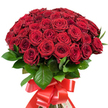 Presented in a radiant dome against a pearl-white backdrop, this generous bouquet features approximately fifty to sixty richly coloured, deep red roses, a vision synonymous with romantic gestures across Clerkenwell. Tightly packed, these roses boast velvety, multi-layered petals-some just emerging as buds, others fully unfurled to reveal their complex interiors. Every bloom is perfectly proportioned and arranged with care, their passionate hues glowing in the clear light, reminiscent of blooms at the foot of St James's Church or in bustling Exmouth Market. Interwoven among the flowers, glossy, dark green leaves add a lively counterpoint and depth, enhancing the sense of natural abundance. The stems, expertly gathered, are wrapped in a wide, lustrous red satin ribbon, tied into an imposing bow whose flowing ends add a final elegant note. This display, crafted for moments of love-be it a milestone anniversary, Valentine's surprise, or a spontaneous show of admiration-captures not just a scene but a feeling: romance, celebration, and heartfelt connection, delivered fresh and full of meaning from a local Clerkenwell florist.