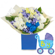 A bright, celebratory floral composition set in a matte royal-blue rectangular gift box, pictured against a clean white background-perfect for welcoming a newborn son. At the heart of the arrangement sit creamy white roses and partially unfurled white lilies, their yellow stamens and trumpet shapes lending a gentle, classical elegance; clusters of full, fluffy white chrysanthemums add soft volume and a comforting cushion of petals. Interspersed are electric blue chrysanthemums that act as vivid focal points, alongside smaller lavender-to-periwinkle clusters reminiscent of hyacinths or campanula that provide delicate texture and a whisper of spring. Fresh green foliage-broad glossy leaves and feathery fern fronds-frames the blooms, giving depth and a natural, hand-gathered silhouette. The bouquet is gathered in crinkled, translucent cream-coloured paper that rustles softly when handled, and the box's rich blue finish anchors the arrangement with a modern, gift-like presence. To the right a light-blue foil balloon shaped like a vintage baby carriage floats slightly; darker blue accents on the canopy and wheels, tiny polka dots and hearts, and playful yellow-and-green lettering proclaiming It's a Boy complete the joyful announcement. The overall impression is one of thoughtful celebration: the cool blues and soft whites create a serene, upbeat palette while the varied textures-from velvety rose petals to the crisp crepe of the wrapping-invite touch and scent. This bouquet feels right for a hospital visit, baby shower, or a welcome-home gift, presented with the quiet confidence of a local florist familiar with Clerkenwell mornings and nearby Exmouth Market deliveries.