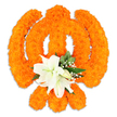 A reverent, freestanding floral Khanda rendered in dense, sunlit orange marigolds sits against a pristine white backdrop, its three-part emblem carved from thousands of tiny, velvety blooms. The circular chakkar reads as a warm halo of compact petals; two crossed kirpans are clearly modelled in bright orange arcs, and the upright double-edged khanda rises with a sculpted firmness-the texture of the marigolds catching the light to create gentle highlights and a soft, tactile depth. At the very centre, where swords would meet, a cluster of pristine white lilies blooms in calm contrast: at least two fully open lilies with softly curved petals reveal pale green-and-yellow stamens, while several smaller buds promise further unfolding. Sprays of tiny white filler flowers-delicate gypsophila-spill around the lilies like a whisper, and glossy green foliage, possibly salal or similar leaves, frames the composition and lifts the orange into clearer focus. A subtle drop shadow beneath the piece gives the impression of a carefully assembled, cathedral-table display rather than a flat motif. The scent reads as a gentle balance too-warm, faintly spicy notes from the marigolds tempered by the cool, sweet perfume of white lilies. As a floral tribute, this Khanda speaks of devotion and celebration with restrained elegance, appropriate for Gurpurab, Vaisakhi, or a memorial setting. A local florist's hand is evident in the symmetry and density of the marigold work; one can imagine this piece placed in a serene Gurdwara corner or on a polished table in Clerkenwell Green under soft morning light, offering both visual clarity and spiritual warmth.