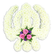 A beautifully composed Sikh Khanda floral tribute stands alone against a spotless white background, its powerful symbol rendered with remarkable precision in snowy white chrysanthemums. The central double-edged sword is clearly visible, rising straight and strong, while the smooth ring of the chakra encircles it and the two kirpans sweep outward in graceful arcs, each curve carefully traced in petals. The chrysanthemums are tightly massed, creating a plush, almost quilted texture that feels soft to the eye, with subtle variations of white and pale cream giving the surface depth and life. At the point where the kirpans nearly meet at the base, a small spray of colour has been tucked in like a tender gesture: three soft pink roses, full and velvety, surrounded by deep purple blooms and fresh green foliage. This gentle combination sits low and central, bringing a quiet warmth and intimacy to the otherwise serene white design. The lighting is even and gentle, accentuating the shadows that define each part of the Khanda, as though the tribute has just been set down in a peaceful room before the arrival of mourners. It feels well suited to a Sikh funeral or remembrance ceremony for a family from Clerkenwell, perhaps travelling from nearby Exmouth Market or Hatton Garden to the Gurdwara. The arrangement, clearly shaped by skilled hands, fuses religious symbolism with the comfort of fresh flowers, offering a calm, respectful presence that honours a life lived with faith and courage.