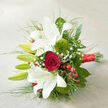 A refined bouquet of white oriental lilies and a single red rose is displayed on a pale, woven linen surface, angled gracefully as though ready to be handed to someone special on a quiet street near St John's Square in Clerkenwell. The lilies unfold in stages: some blossoms open wide to reveal satin-smooth white petals with delicate reddish speckles at their throats, while others remain as elongated green buds brimming with promise. At the centre, one deep crimson rose takes focus, its tightly layered, velvety petals curling inwards in a perfect spiral that suggests enduring love and intimate vows. Around these focal blooms, two bright green, fuzzy Green Trick dianthus add sculptural, almost moss-like spheres of texture, giving a modern edge to the classic palette. Wisps of fine white baby's breath weave gently between the flowers, creating a dreamy, cloudlike softness, while shiny clusters of red hypericum berries add berry-bright accents that feel festive yet refined. The bouquet is padded with a generous mix of foliage: broad, dark green leaves that ground the design, and slender, feathery greens that arc outward like painterly strokes, adding movement and air. All the stems are drawn together in a neat bundle, cinched with a luxurious red satin ribbon whose sheen echoes the warmth of the rose and drapes slightly towards the bottom right corner. Soft daylight spills across the scene, casting light shadows that define each bloom without harshness. The overall effect is of understated luxury and romance, ideal for a Clerkenwell wedding ceremony, anniversary dinner near Farringdon, or a romantic same-day delivery from a trusted local florist.