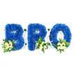 An eye-level studio portrait on a pristine white background presents a three-piece, freestanding tribute spelling BRO in large capital letters. Each letter - B, R and O - is built from densely packed, royal blue chrysanthemum heads, their tiny petals layered to create a velvety, tactile surface that reads both bold and tender from a short distance. The blue is deep and saturated, a marine, almost ink-like tone that calms the eye and suggests quiet reflection. Along the bottom curves and edges of each letter sit small accent clusters: pale ivory to soft buttery-yellow spray roses, some in tight buds and others with petals unfurling, set with petite white filler blooms (mini chrysanthemums or fine sprays of baby's breath) and a mix of glossy salal leaves and delicate, fern-like fronds. The contrast between the plush blue mass and the creamy, luminous accents softens the composition and adds visual warmth.
A thin white frame and base are visible around the letters and in the open counters of B, R and O, indicating floral foam or a sturdy support beneath the flowers - a respectful construction typical of memorial pieces. The studio light is even and gentle, bringing out texture without harsh shadows so the arrangement reads clearly for viewing at a wake or service. The scent is faintly green and floral, the roses offering a soft sweetness against the clean brightness of the white base. Intended as a sympathetic tribute for a brother or close friend, the piece conveys solemnity, loyalty and remembrance - qualities families in Clerkenwell and neighbouring Farringdon often request when ordering a personalised memorial tribute.
