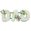 An elegant funeral tribute for a father is presented in the image: the word DAD formed in tall, three-dimensional letters, each one completely cloaked in pure white chrysanthemums that create a velvety, cloud-like surface. Every bloom is fresh and tightly nestled next to its neighbour, giving the letters a full, carefully groomed appearance that suggests experienced hands have shaped them, like those at Clerkenwell Flowers preparing a display for a local service. Around the outer edge of each letter runs a gleaming band of emerald green satin ribbon, gathered into soft ruffles that offer crisp definition and a gentle pop of colour against the white petals. Faint glimpses of a dark metal frame and connecting bars can be seen behind the flowers, indicating that the tribute is designed to stand upright as one continuous piece during a funeral ceremony or memorial gathering. At the upper left curve of the first D, a small cluster of white freesias and polished green foliage rests delicately, their slender forms adding texture and a hint of natural movement. From this accent, two long, arching green stems travel diagonally across towards the central A, where they open into a striking yet understated spray. Here, two deep purple calla lilies with graceful, trumpet-shaped blooms sit among more white freesias and vivid green leaves, their darker hue bringing a thoughtful contrast that feels both contemporary and timeless. The final D on the right is topped at its upper right side with a smaller echo of freesia and greenery. Taken together, the piece conveys profound love, remembrance, and quiet sorrow, an appropriate floral letter tribute for honouring a dad at funerals or wakes around Clerkenwell and nearby Holborn.