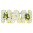 A carefully modelled, three-dimensional funeral tribute spelling the affectionate word NAN in bold capital letters, crafted from hundreds of small white chrysanthemums that form a cloud-soft, textured surface across each letter. A lively band of smaller, bright yellow button chrysanthemums traces the outer edges of every letter, providing a cheerful, sunlit outline that crisply defines the forms against the pure white background. The two N letters are each finished with a compact accent cluster of glossy deep green foliage-smooth camellia-like leaves or ruscus-and a scattering of tighter yellow blooms or rosebuds that sit just inside the yellow border, introducing a warm focal point without overwhelming the clean white face of the central A, which is deliberately left unadorned to emphasize purity and calm. Behind the upper sections a discreet dark green support bar links the letters, suggesting a free-standing design meant to be placed on a church plinth or graveside stand. The arrangement's textures are tactile in description: the cushiony chrysanthemum sprays, the satiny sheen of tiny yellow buttons, and the cool, waxy feel of the deep foliage-together evoking the quiet dignity of a memorial. Soft studio light in the photograph washes the whites with subtle shadow, allowing the yellow edges to lift forward and the greens to read as fresh and rooted. As a local florist in Clerkenwell might explain, this style of personalised letter tribute is chosen to honour a dearly loved Nan with both reverence and a hopeful, sunny accent; its compact clusters and clean lines make it suitable for chapel display, a service at St John's, or a graveside remembrance in the area.